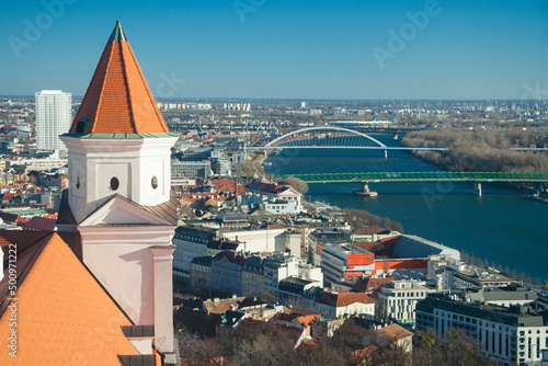 Slovakia - Bratislava - Tower of Bratislava (Pressburg) castle (hrad) with Danube (Dunai) bridges on background. Space for text photo