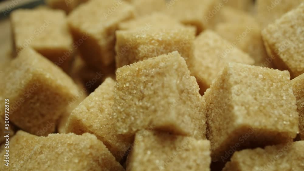 Rotating brown sugar cubes. Brown sugar cubes moving on a turntable Rotating brown sugar cubes. Brown sugar cubes moving on a turntable
