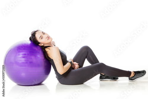 Beautiful woman leaning on the yoga ball