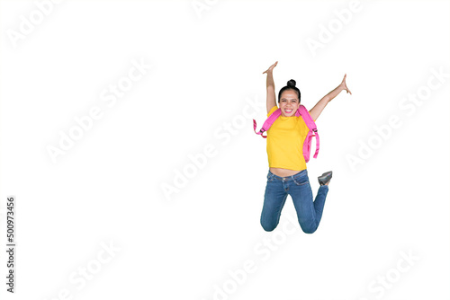 Happy female student jumping on studio
