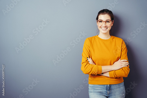 Photo of attractive charming lady cute arms crossed self-confident person worker friendly smile good mood isolated blue color background
