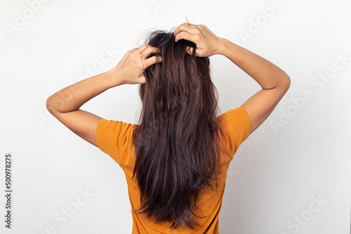 Women itching scalp itchy his hair and was massage her hair on a white background,Haircare concept
