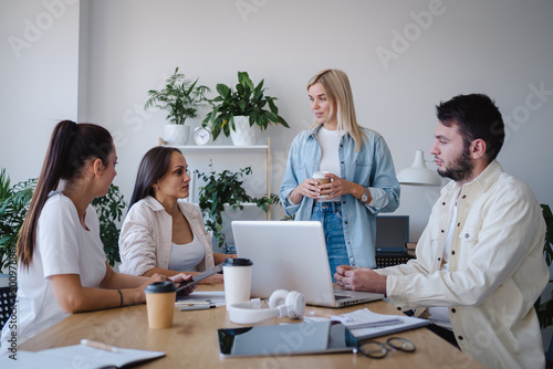Serious employees and ceo gathered in boardroom and discuss financial report