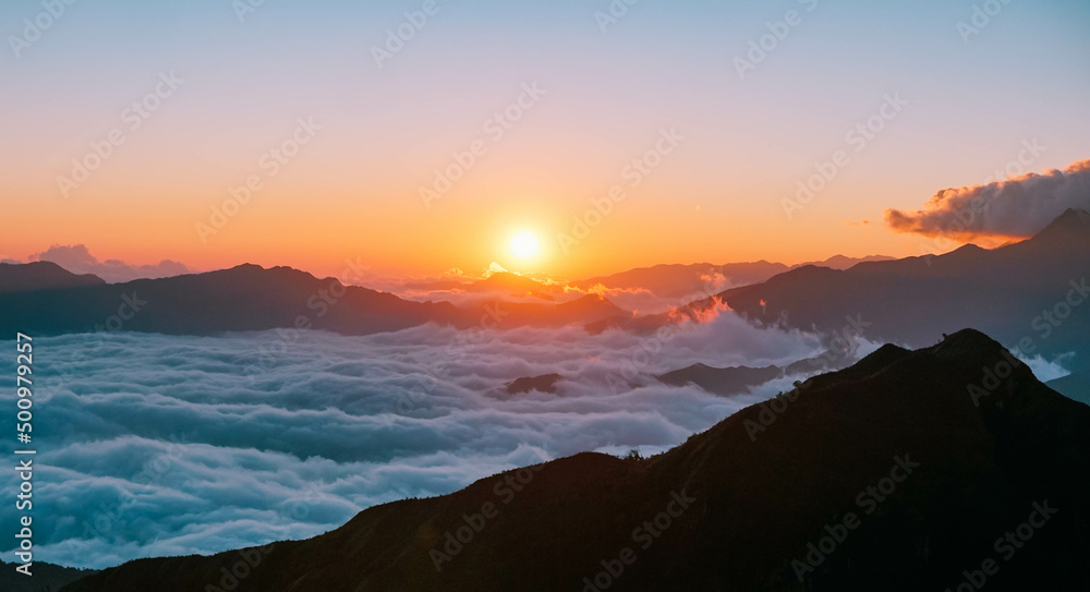 Seeing the sunrise on the sea of clouds on mountain top after a trek gives the feeling of peace, serenity and is a good practice of mindfulness. Seeing the sunrise on the sea of clouds on mountain top after a trek gives the feeling of peace, serenity and is a good practice of mindfulness.
