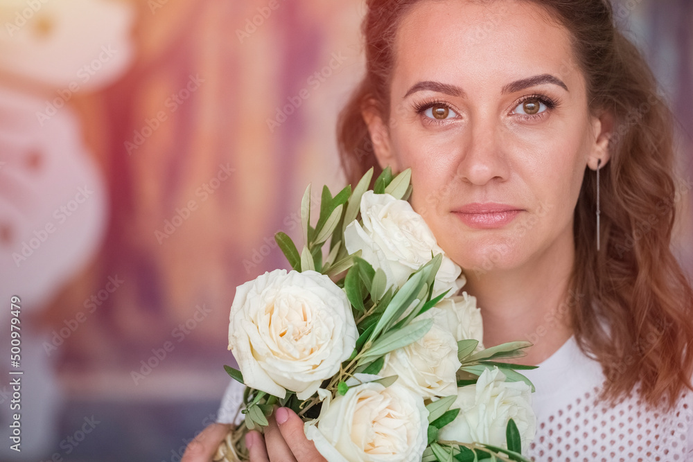 Naklejka premium Woman with a beautiful bouquet of flowers, white roses. Place for text, copy space. Toning