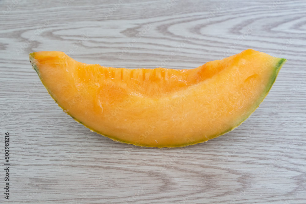 Piece of melon on wooden background Piece of melon on wooden background