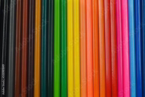 Colored pencils lie in a row. The perfect blank for your desig.Top view. 