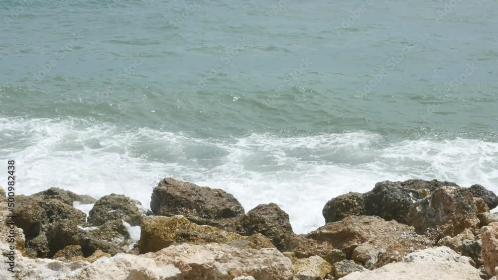 BALI, INDONESIA - JANUARY 22, 2018: Beautiful ocean waves hit rocks near Pandawa Beach, Bali. 4K, Handheld