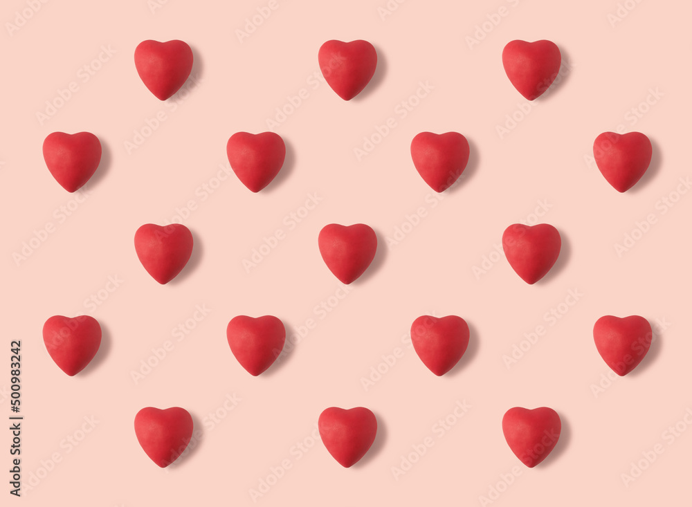 Plasticine hearts arranged in a pattern on a pink background. Handmade hearts from plasticine. 3d artwork