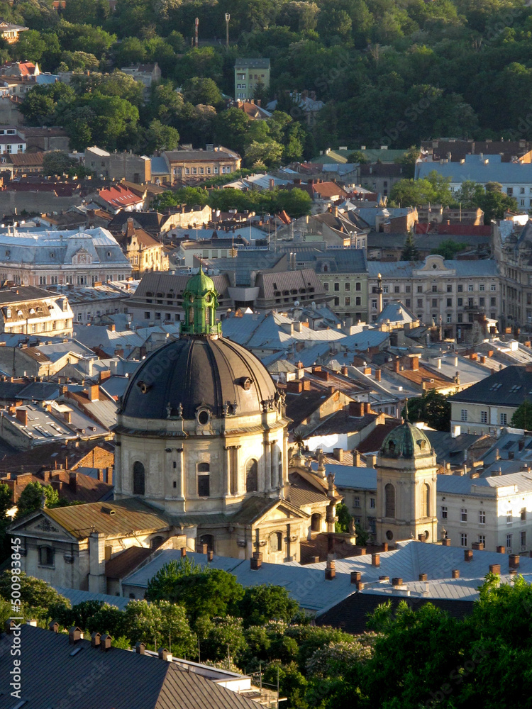 Top view of the roof of an old European city - Lviv. Old architecture, old metal rusted roofs, view of the city from the town hall at sunset. View of an old European city from a height 