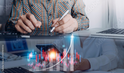 Fototapeta Naklejka Na Ścianę i Meble -  planning and strategy, Stock market, Business growth, progress or success concept. Businessman or trader is showing a growing virtual hologram stock, invest in trading.