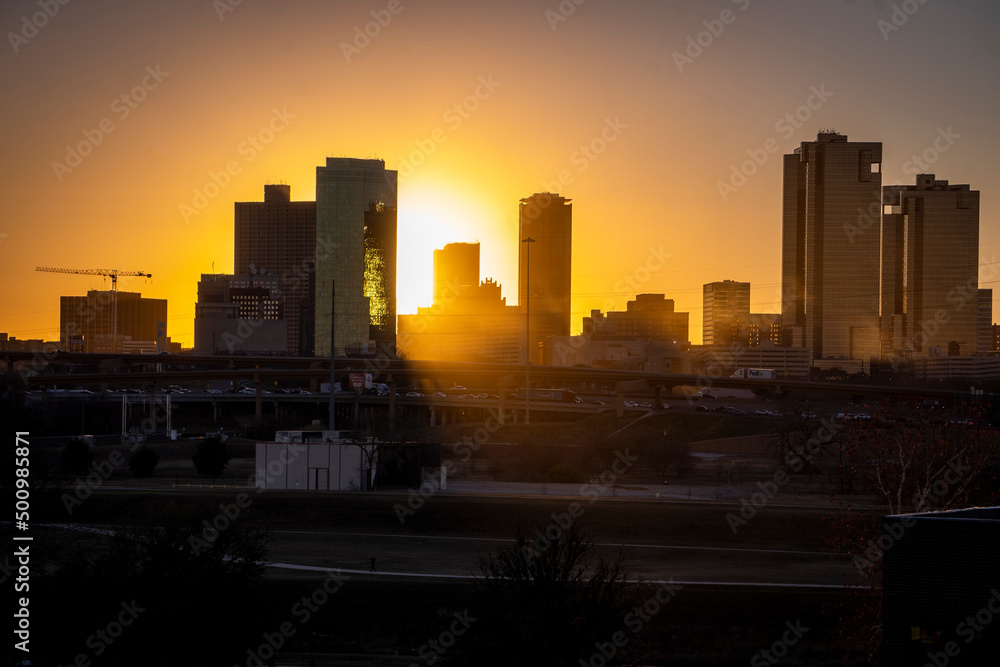 Fort Worth, TX USA - March 19, 2022: Sun setting during rush hour traffic in Downtown Fort Worth