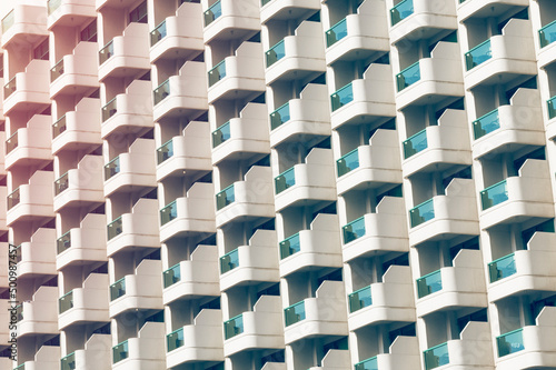 Facade of a skyscraper with open balconies. Background  texture