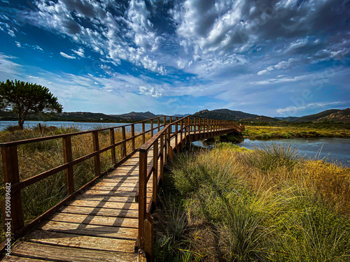 Porto Taverna - Sardegna  Sardinia  Italy. Close to Porto Taverna Beach  not so far from Olbia. Wooden bridge over lake with cloudy weather.