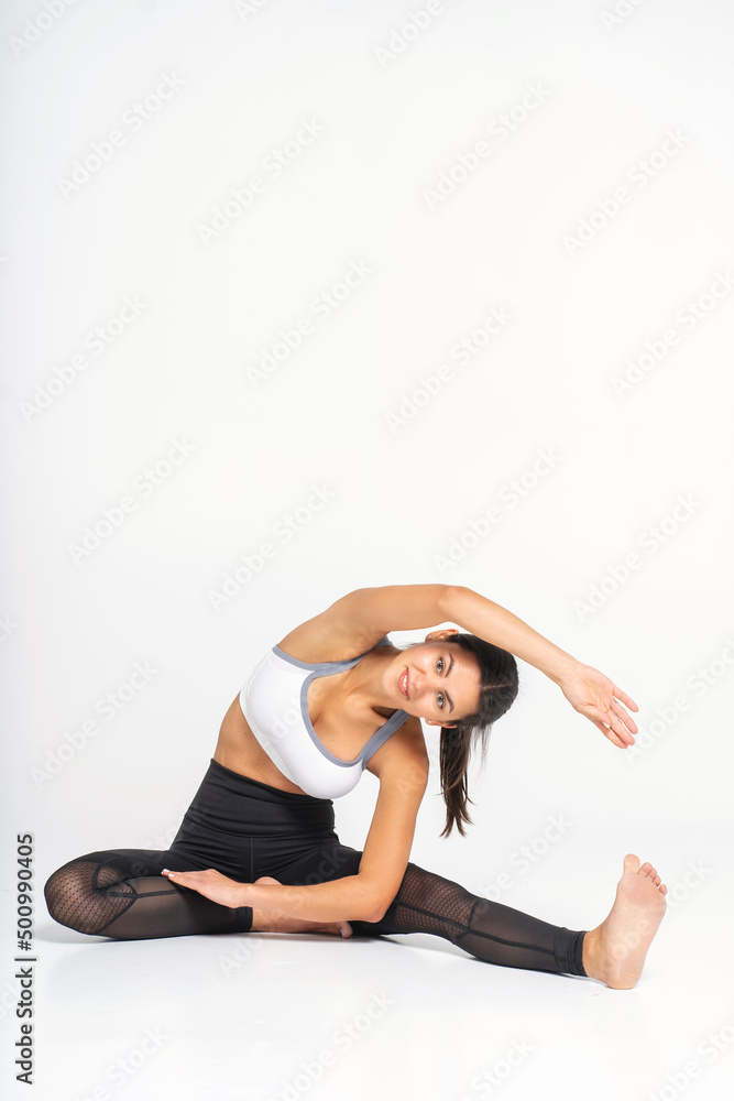 woman trainer doing stretching before doing sports. Photo on a white background woman trainer doing stretching before doing sports. Photo on a white background