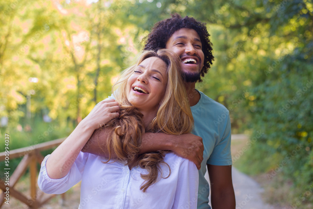 Young couple hugging in the nature on a sunny summer day