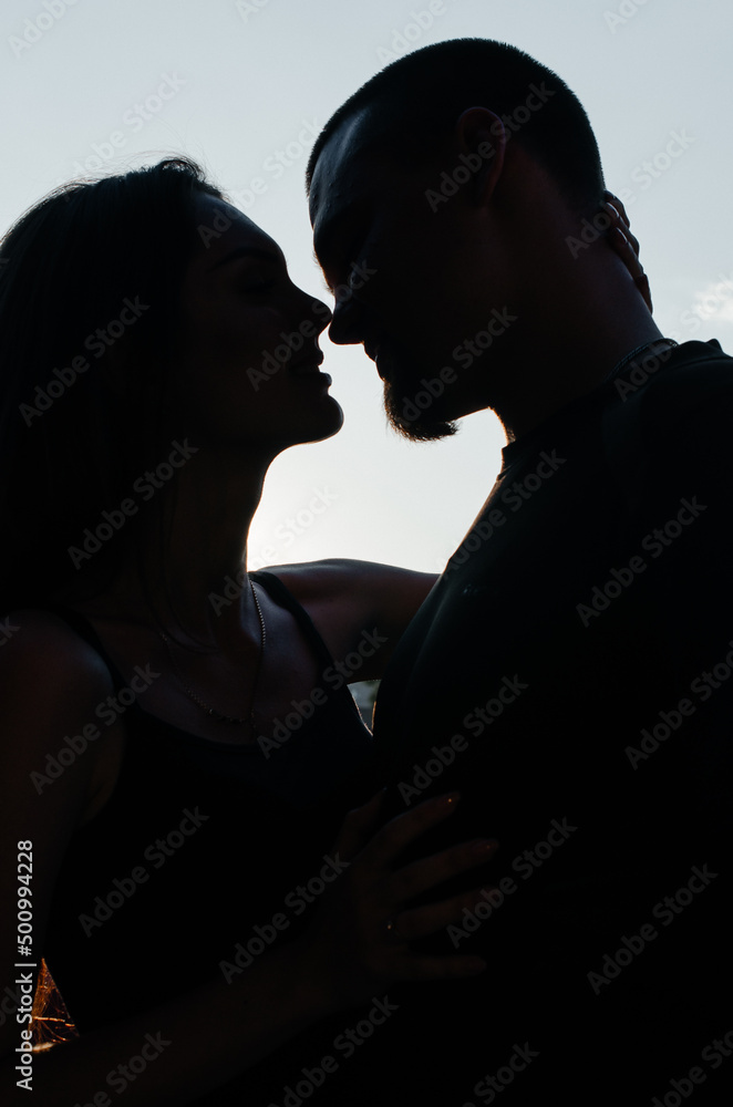 silhouette of man and woman that hug