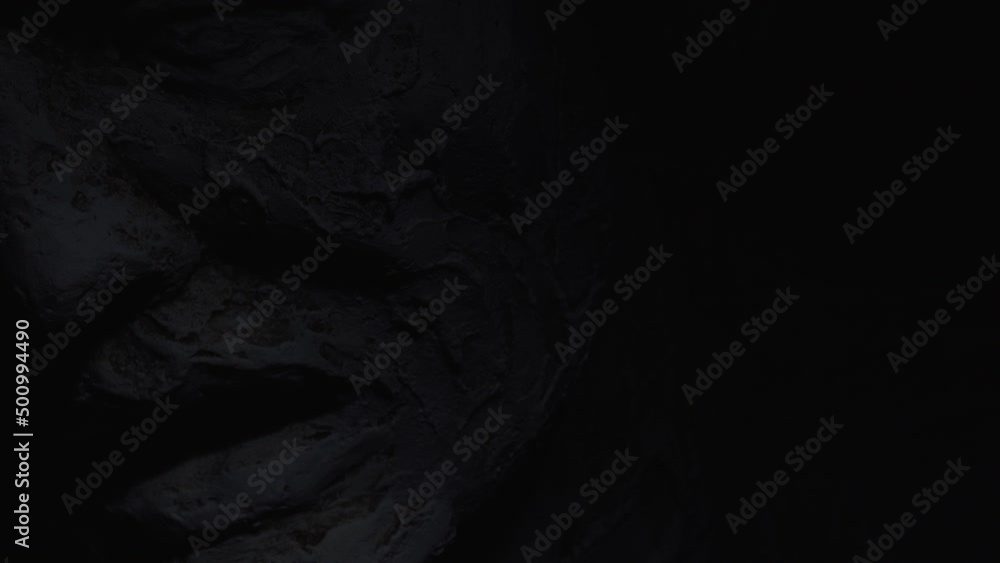 A white statue of a man. A close-up shot on a black background. A white statue of a man. A close-up shot on a black background.
