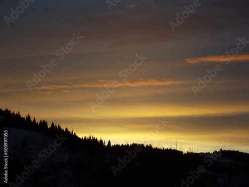 The sun disappeared behind the mountain. Beautiful sunset © Ivan Koliadzhyn