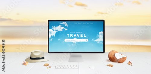 Search for summer travel destinations online concept. Computer display on desk with sea and beach in background. Travel concept