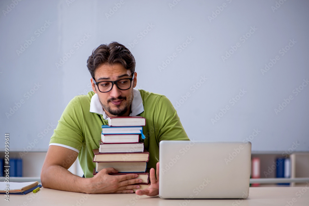 Young male student preparing for exams in the classroom Young male student preparing for exams in the classroom