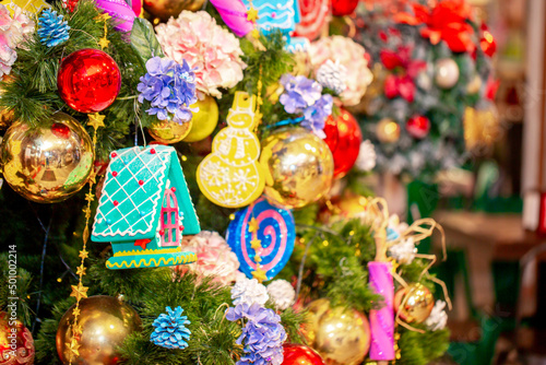 Christmas decorations in the interior. Festive background. New Year's room design, beautiful and shiny toys on the Christmas tree. Blurred background with copy space for text.