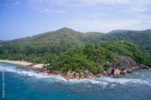 Drone field of view of coastline, mountains and beach in Praslin, Seychelles.