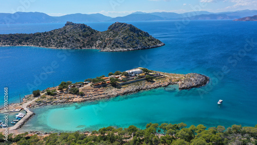 Aerial drone photo of iconic Aponisos bay and lake with clear turquoise sea and pine trees, Agistri island, Saronic gulf, Greece