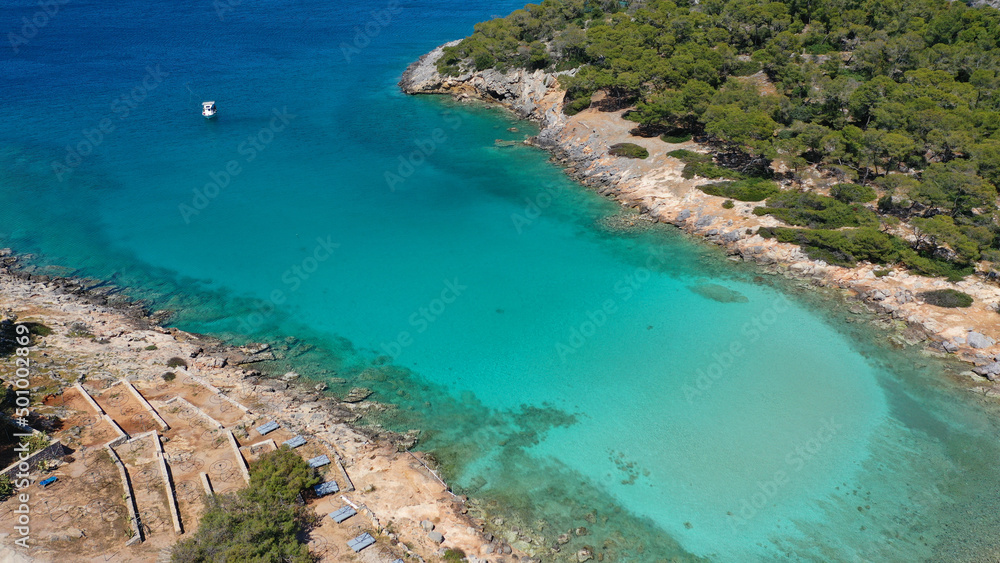 Aerial drone photo of iconic Aponisos bay and lake with clear turquoise sea and pine trees,  Agistri island, Saronic gulf, Greece