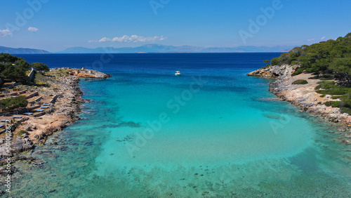 Aerial drone photo of tropical exotic paradise island bay with deep turquoise sea forming a blue lagoon visited by luxury yachts and sail boats © aerial-drone
