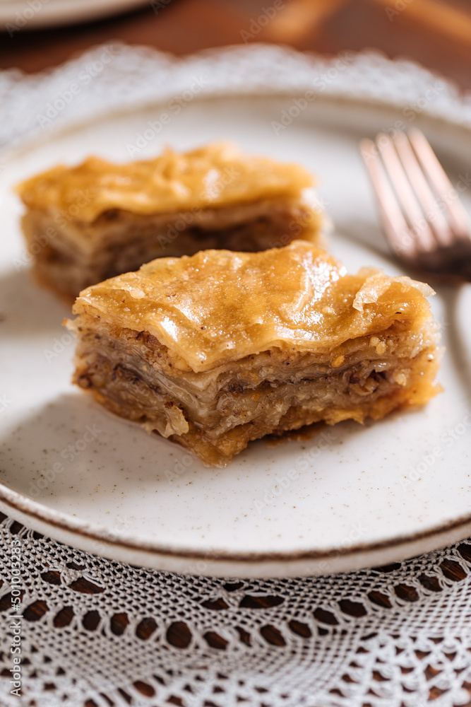 Turkish or Bosnian dessert called Baklava with on a wooden board. Popular dessert for Ramadan and Eid Mubarak Turkish or Bosnian dessert called Baklava with on a wooden board. Popular dessert for Ramadan and Eid Mubarak