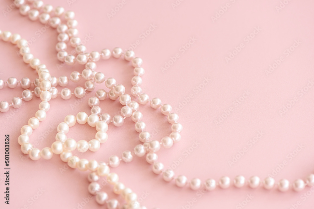 Pink pastel pearls bead on cute rose background with copy space. Soft focus