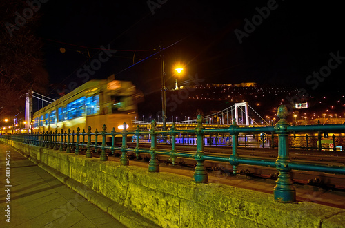 The riding tram against Elisabeth Bridge, Budapest, Hungary photo