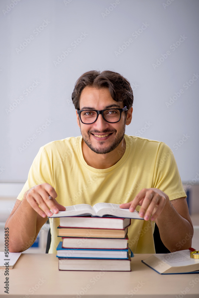 Young male student preparing for exams in the classroom Young male student preparing for exams in the classroom