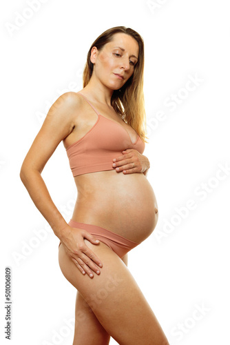Pregnant woman pose in profile view with big belly