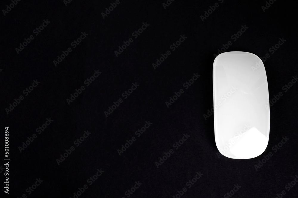 Modern slack wireless white computer mouse on black background. Modern slack wireless white computer mouse on black background.
