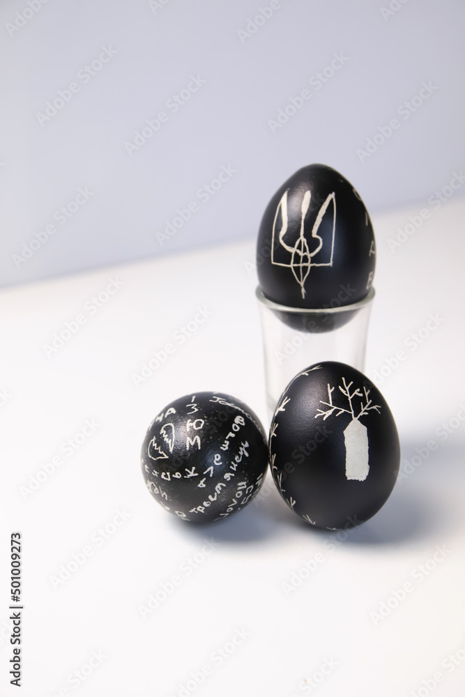 Defocus black eggs on white background. Minimal Easter celebration concept. Design, visual art, minimalism. Balance and harmony concept. Mental health. Pattern. Ukrainian symbol. Out of focus Defocus black eggs on white background. Minimal Easter celebration concept. Design, visual art, minimalism. Balance and harmony concept. Mental health. Pattern. Ukrainian symbol. Out of focus