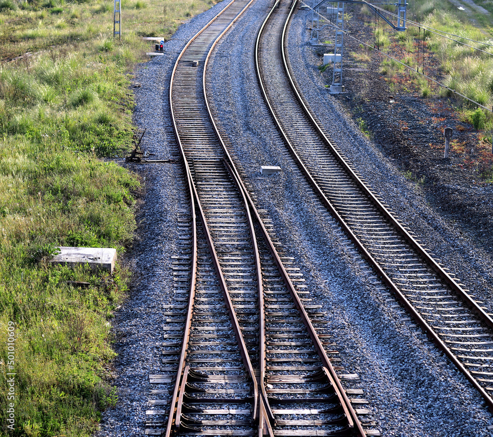 Train tracks that curve and disappear into the distance Train tracks that curve and disappear into the distance