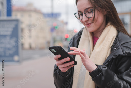 beautiful stylish young girl with phone in urban