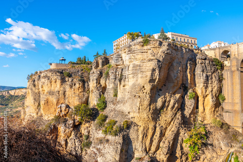 The high cliffs, town and lookout point alongside the bridge in the Andalusian village of Ronda, Spain.