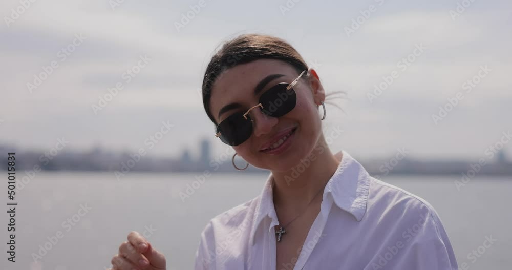 Smiling woman in white shirt on a beach, slow motion Smiling woman in white shirt on a beach, slow motion