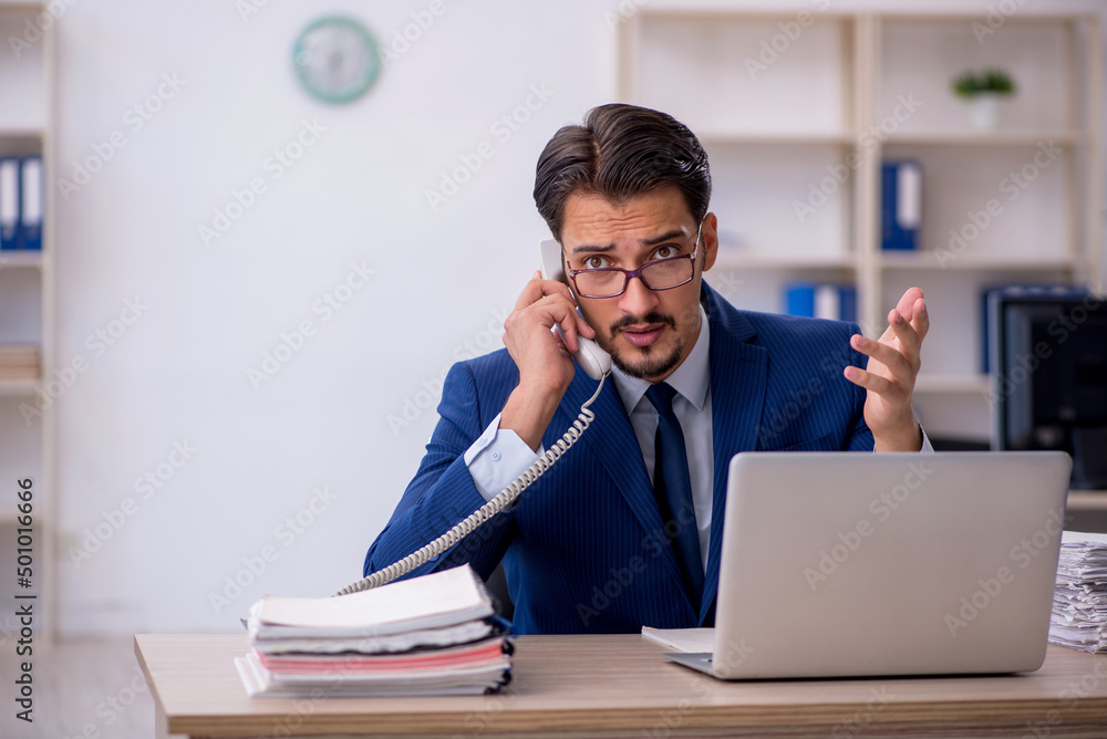 Young male employee working in the office Young male employee working in the office