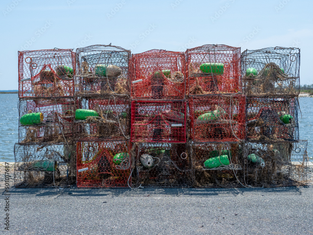 Crabpots stacked outside on a dock waiting to be used by commercial fisherman