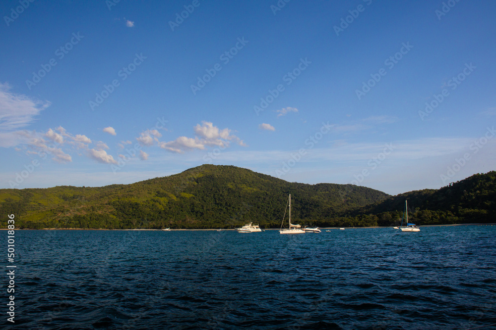 Boats, speedboats and sailboats in tropical and paradise landscape with blue sky of the coast of Ubatuba - Brazil