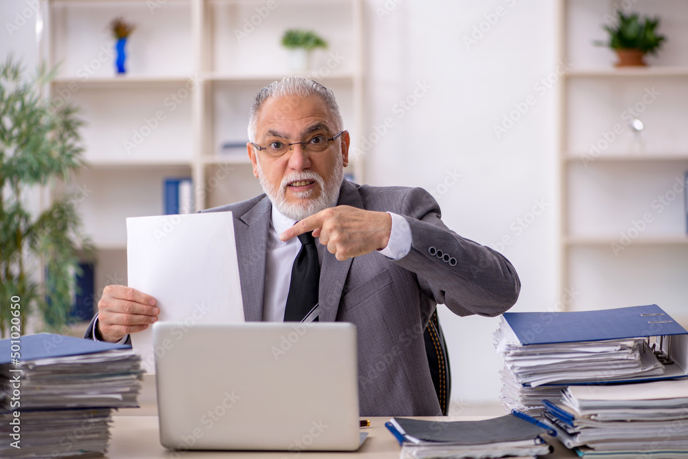 Old male employee and too much work in the office Old male employee and too much work in the office