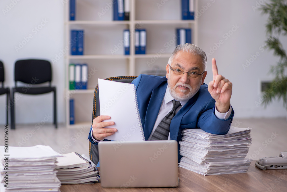 Old male employee and too much work in the office Old male employee and too much work in the office