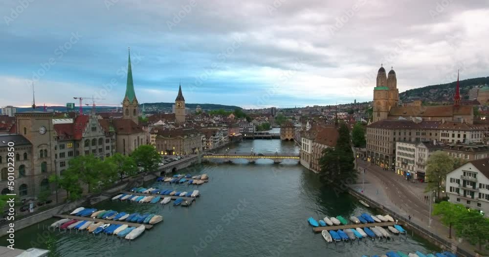 Aerial Forward Sot Of Religious Gothic Buildings Against Cloudy Sky, Drone Flying Backwards Over Lake In City - Zurich, Switzerland Aerial Forward Sot Of Religious Gothic Buildings Against Cloudy Sky, Drone Flying Backwards Over Lake In City - Zurich, Switzerland