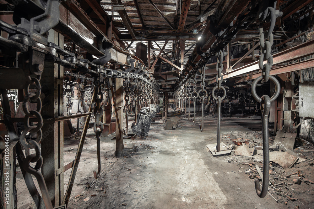  Stopped overhead conveyor with hooks for fastening parts on abandoned plant