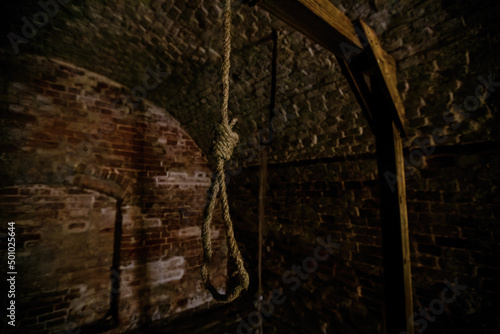 Foto Hanging noose of rope in dark creepy abandoned cellar