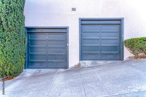 Two black garage doors near the sloped street in San Francisco, Calfiornia photo